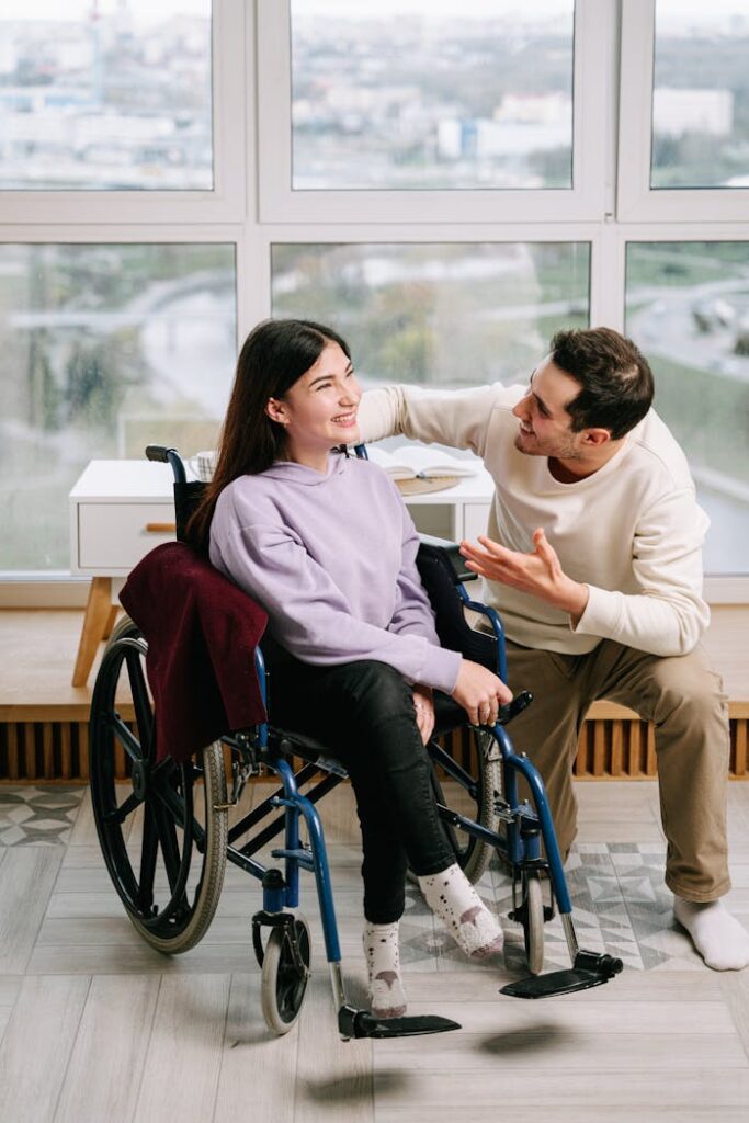 man-smiling-at-the-woman-in-wheelchair-8127425 Man Smiling at the Woman in Wheelchair