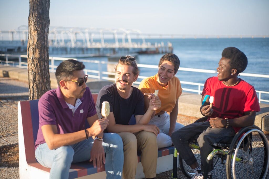 people-holding-ice-cream-while-sitting-on-a-bench-8777827 People Holding Ice Cream While Sitting on a Bench